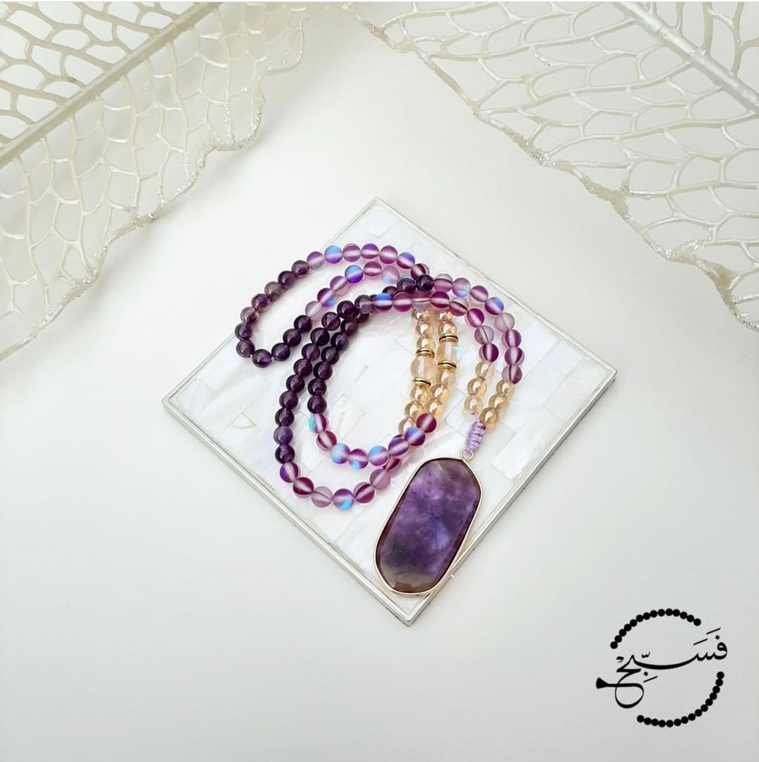 This tasbih has an amethyst pendant with amethyst, purple moonstone and gold beads. Packaged in a luxurious pouch and a gift box. 99 beads