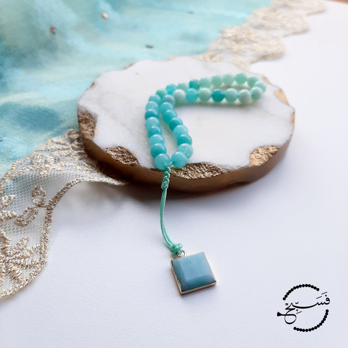 Amazonite beads, with amazonite pendant. Features an adjustable knot. 33 beads (6mm beads)