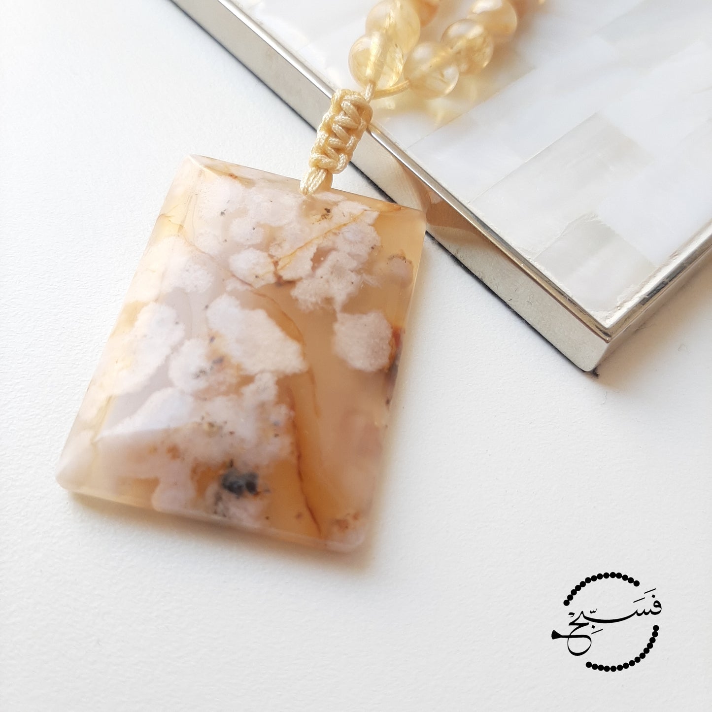 This chunk of cherry blossom agate needed no embellishments! Smooth and cool to the touch. This one feels really good in your hands. The beads are a mix of smoky quartz and trochus shell, and they match beautifully with the pendant.  Packaged in a luxurious pouch and a gift box.  99 beads
