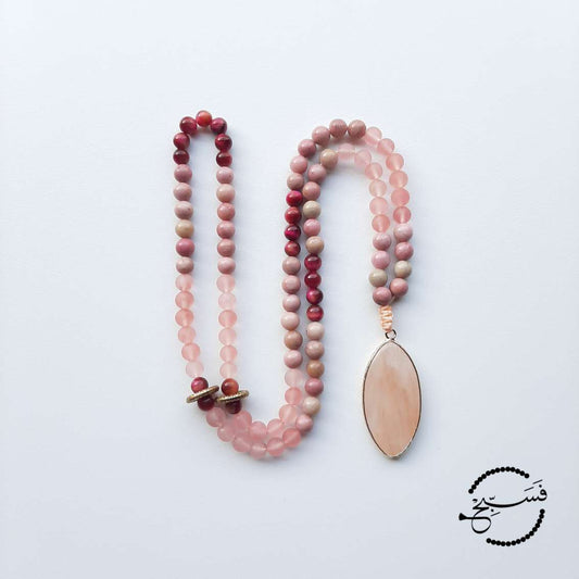 This piece is made from watermelon quartz, pink rhodonite and rose tiger eye beads. A beautifully shaped quartz pendant completes the piece. Packaged in a luxurious pouch and a gift box. 99 beads