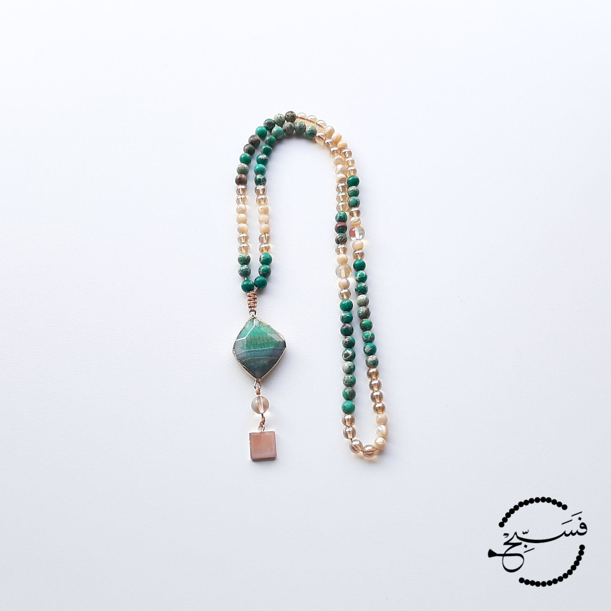 Shades of gold and beige trochus shell are combined with gorgeous deep green sea sediment beads. Complimented beautifully with two pendants: Brazilian green agate and quartz.  Packaged in a luxurious pouch and a gift box.  99 beads
