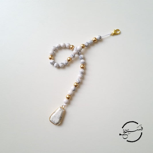 Stunning white howlite & matte gold beads paired with a white howlite pendant. 33 bead tasbih that can be clipped onto your bag. Packaged in a luxurious pouch and a gift box.