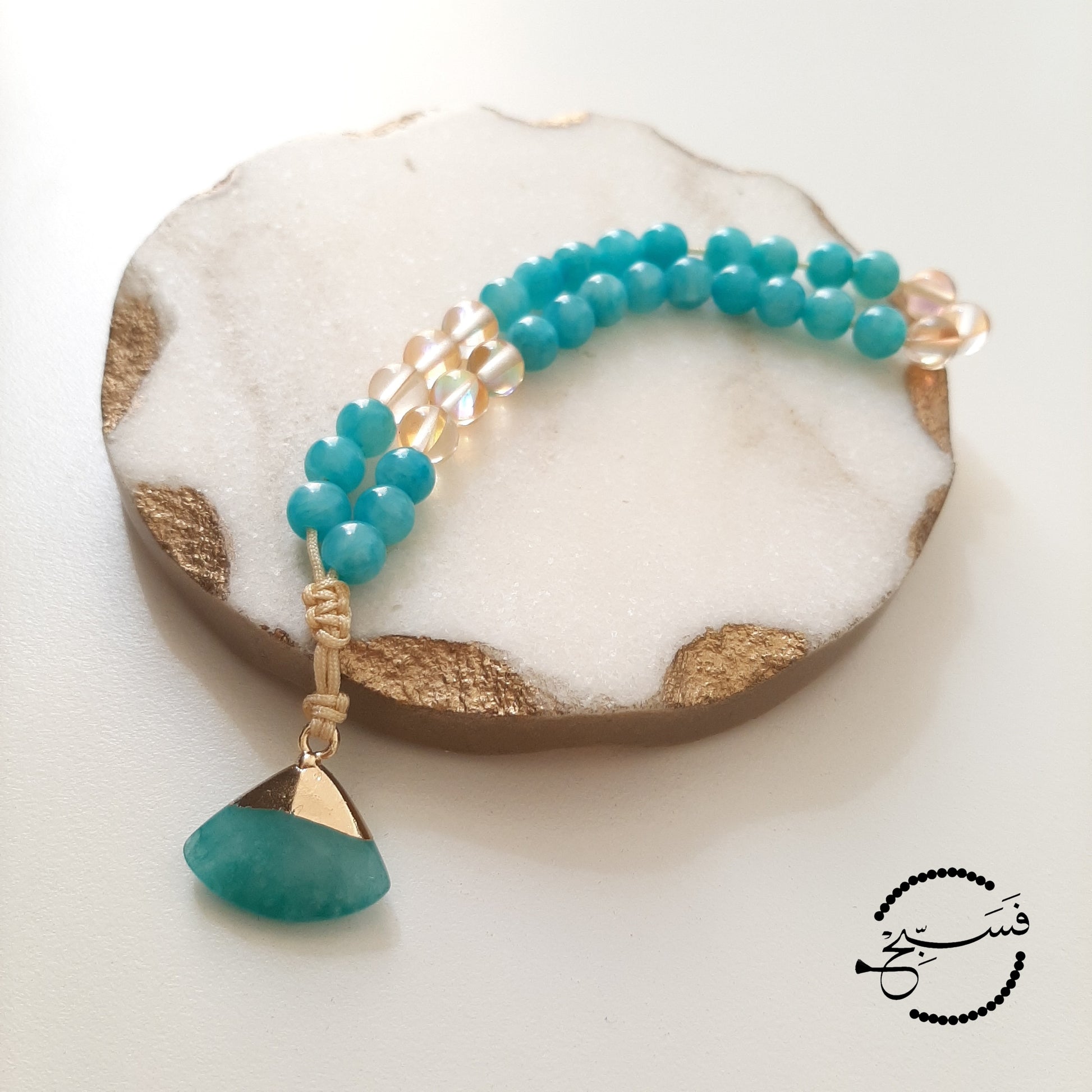 Natural amazonite with gold moonstone beads and a quartz pendant.  Features an adjustable knot.  33 beads (6mm beads)