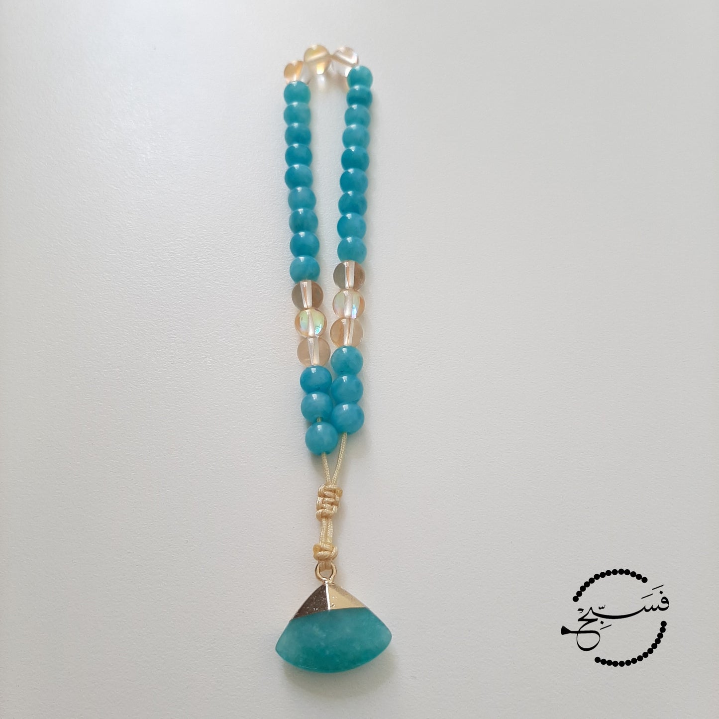 Natural amazonite with gold moonstone beads and a quartz pendant.  Features an adjustable knot.  33 beads (6mm beads)