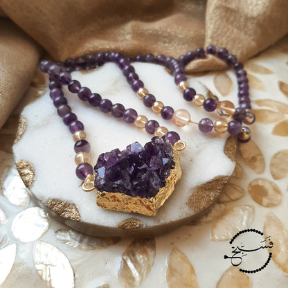 An absolutely stunning amethyst crystal pendant with 24K gold plating, paired with some lovely amethyst beads.   Packaged in a luxurious pouch and a gift box.  99 beads