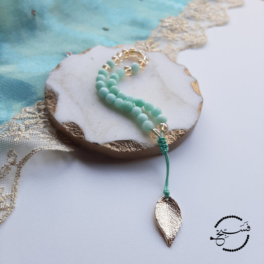 Amazonite and gold beads, with a brass leaf.  Features an adjustable knot.  33 beads (6mm beads)