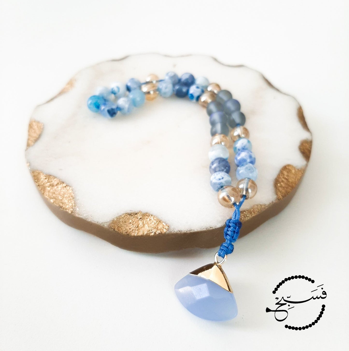 Blue fire agate and moonstone beads, with a pale blue quartz pendant.  Features an adjustable knot.  33 beads (6mm beads)