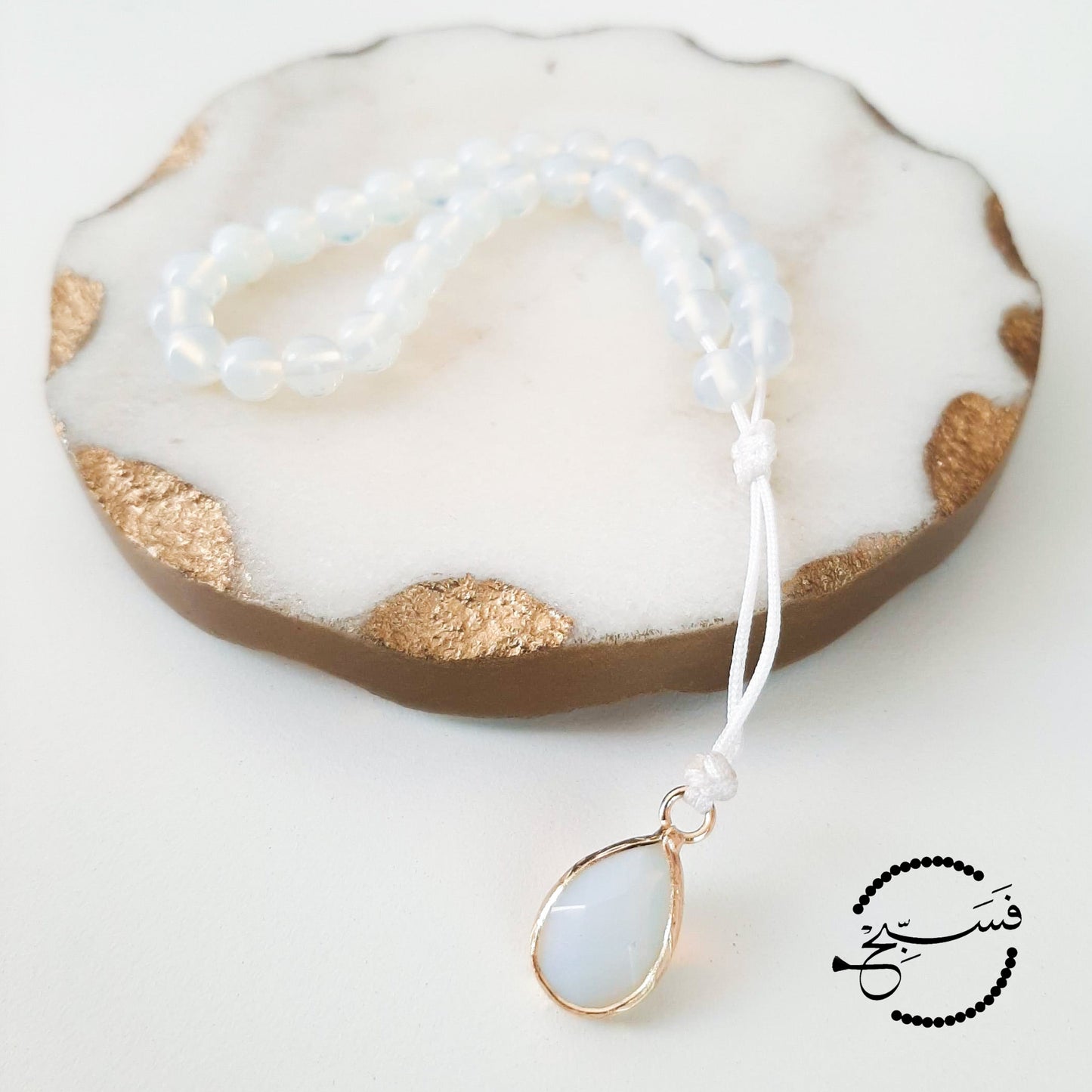 White agate beads, with a white pendant.  Features an adjustable knot.  33 beads (6mm beads)