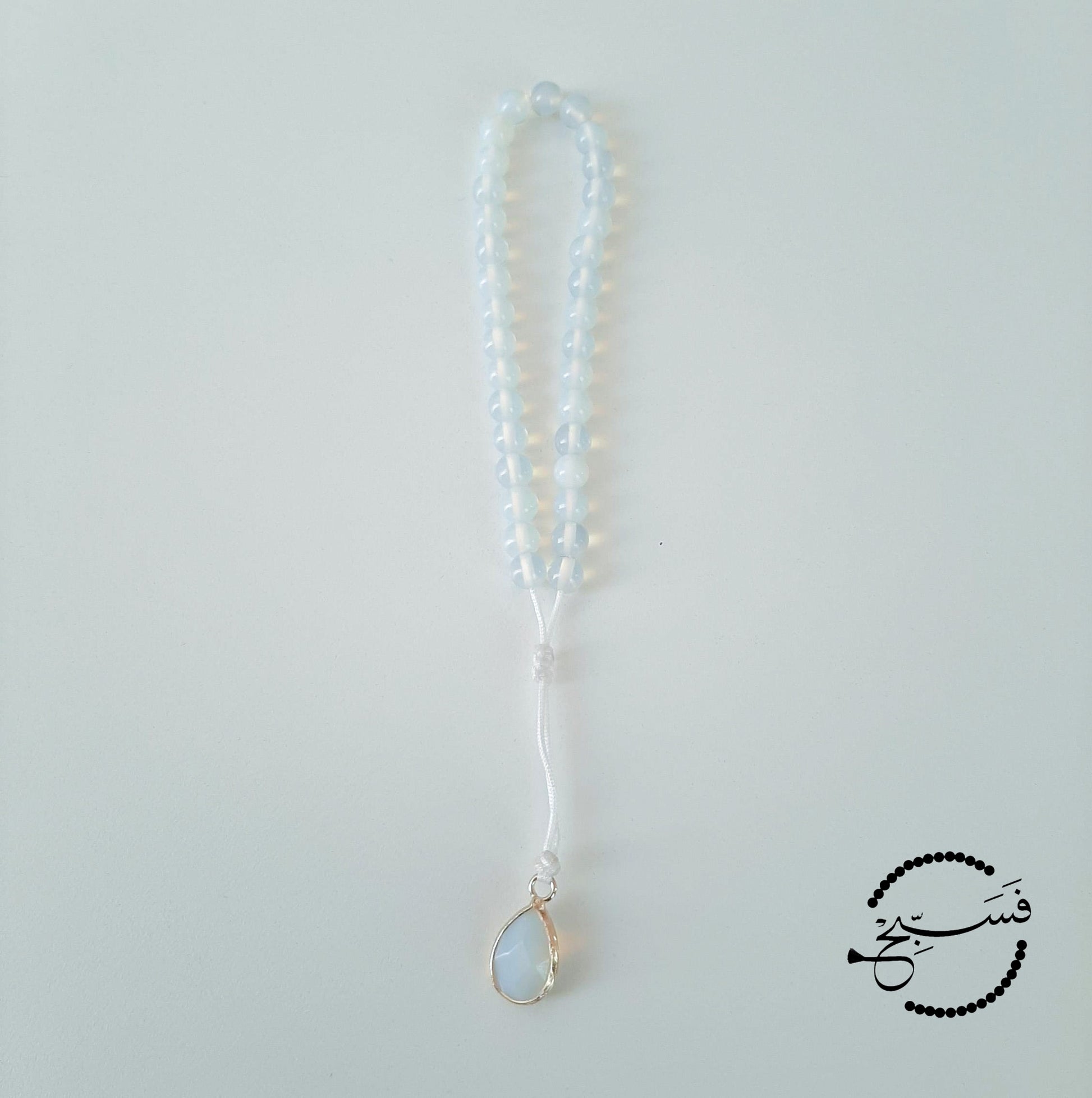White agate beads, with a white pendant.  Features an adjustable knot.  33 beads (6mm beads)