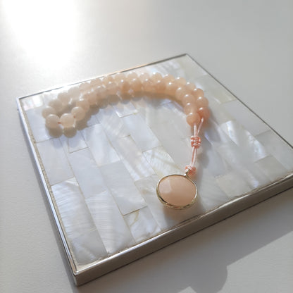 Pink aventurine bracelet, with a jasper pendant.  Features an adjustable knot.  33 beads (6mm beads)