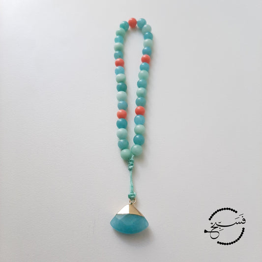 Amazonite & coral beads, with amazonite pendant.  Features an adjustable knot.  33 beads (6mm beads)