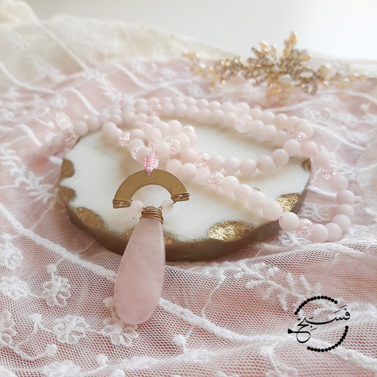 Don't you just love the delicate pink shade of rose quartz? This piece features a beautiful rose quartz stone, paired with rose quartz beads and pink crystal beads.  Packaged in a luxurious pouch and a gift box.  99 beads