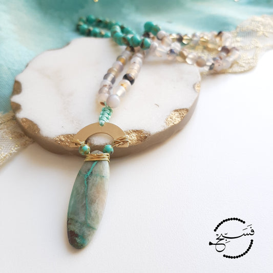 Made using sea sediment and agate beads completed with a chrysocolla stone pendant.  Packaged in a luxurious pouch and a gift box.  99 beads