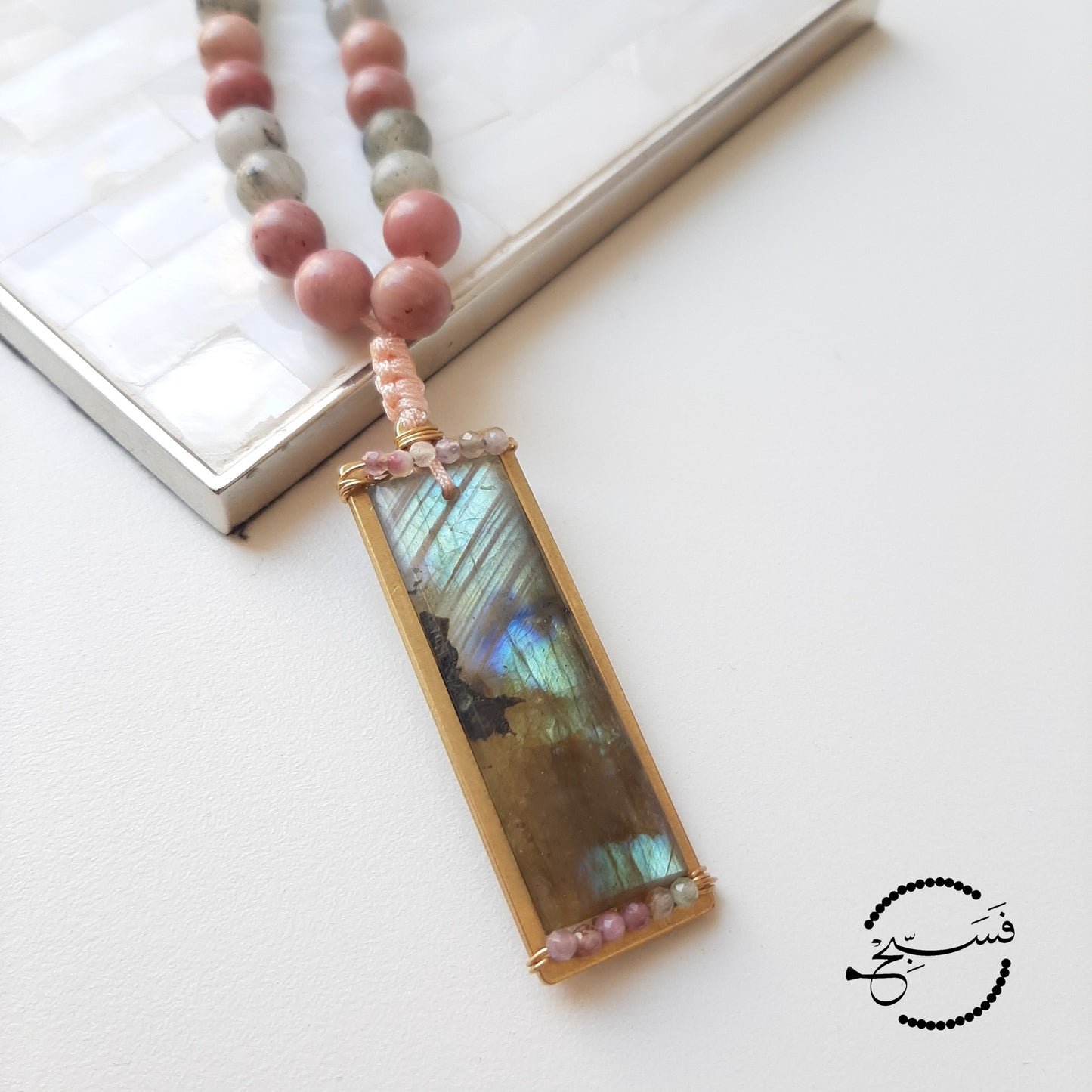 A stunning flat labradorite stone, carefully crafted into a pendant with tiny natural tourmaline beads. The tasbih beads are labradorite and rhodonite.  Packaged in a luxurious pouch and a gift box.  99 beads