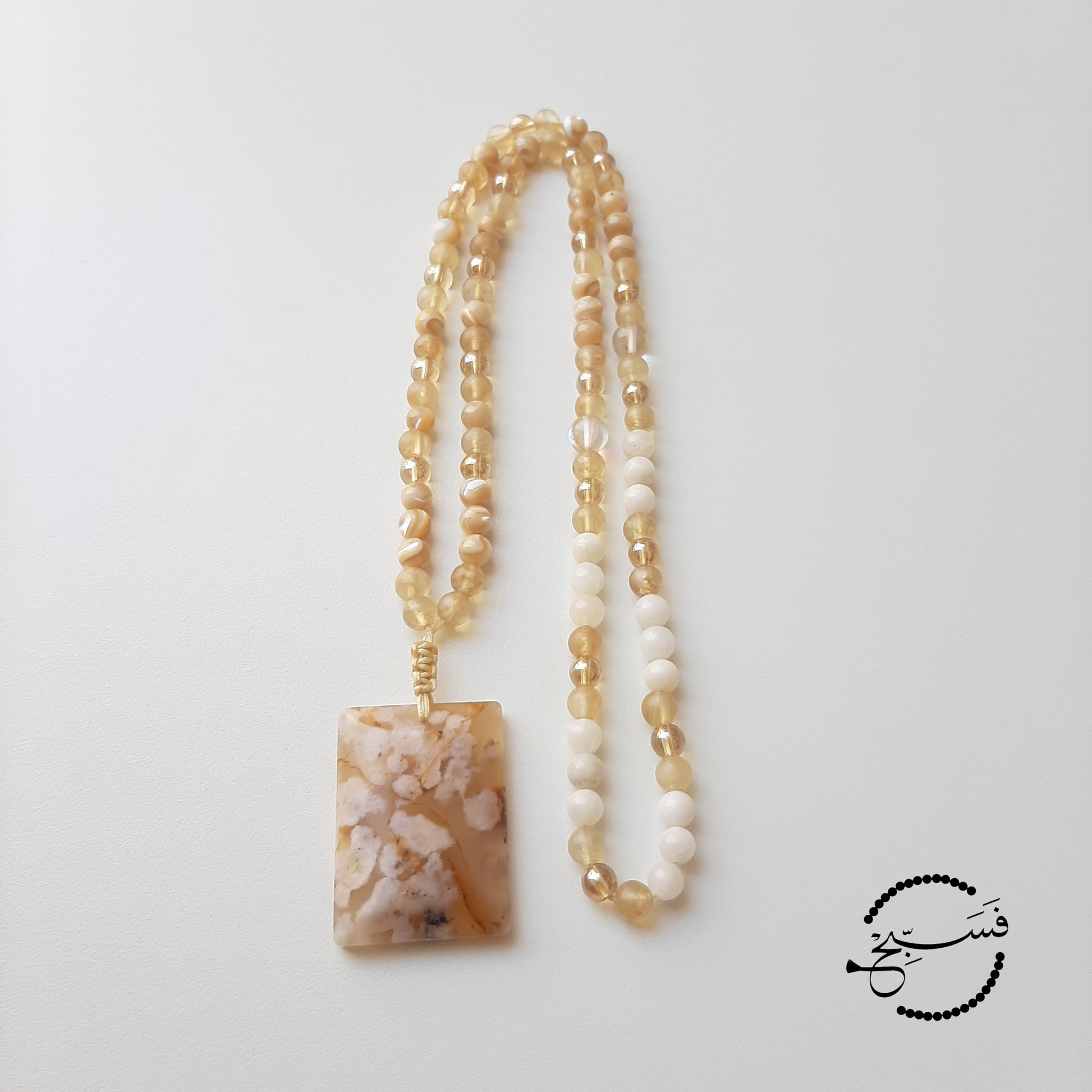 This chunk of cherry blossom agate needed no embellishments! Smooth and cool to the touch. This one feels really good in your hands. The beads are a mix of smoky quartz and trochus shell, and they match beautifully with the pendant.  Packaged in a luxurious pouch and a gift box.  99 beads