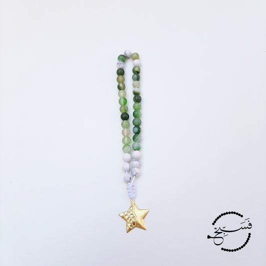 Green agate and white howlite beads, with a brass star pendant.  33 beads