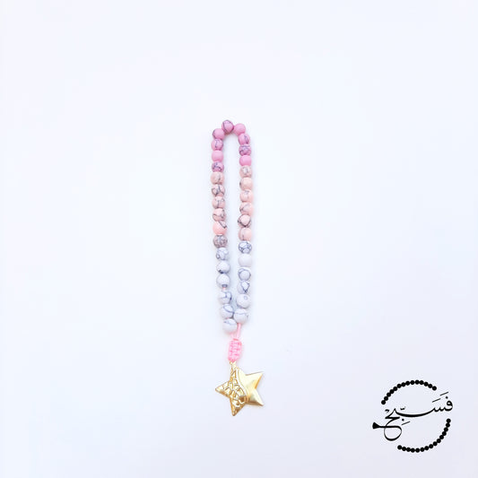 Howlite beads with a brass star pendant.  33 beads.