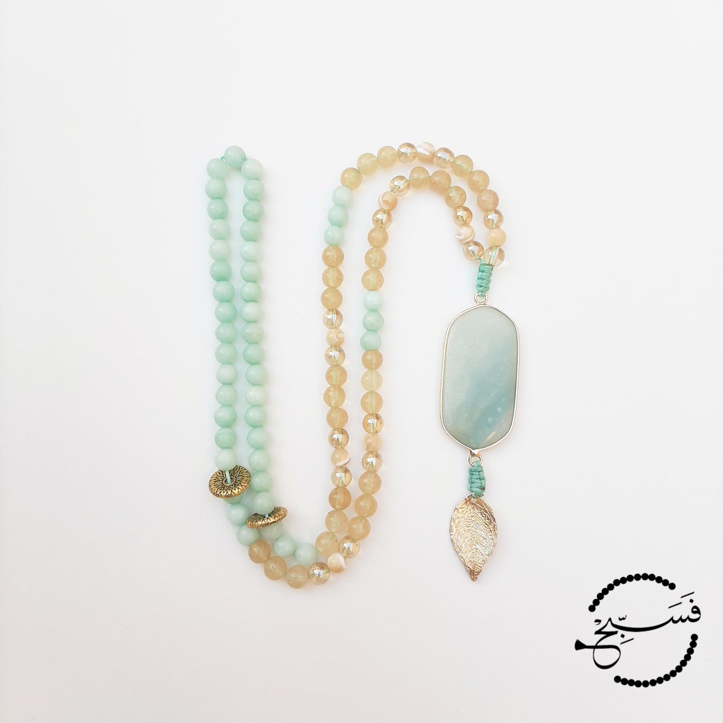 Amazonite. Dreamy shades of turquoise. Here we have used the lighter shade of amazonite with gold and natural trochus shell beads. Finished with an amazonite pendant and a gold leaf.  Packaged in a luxurious pouch and a gift box.  99 beads