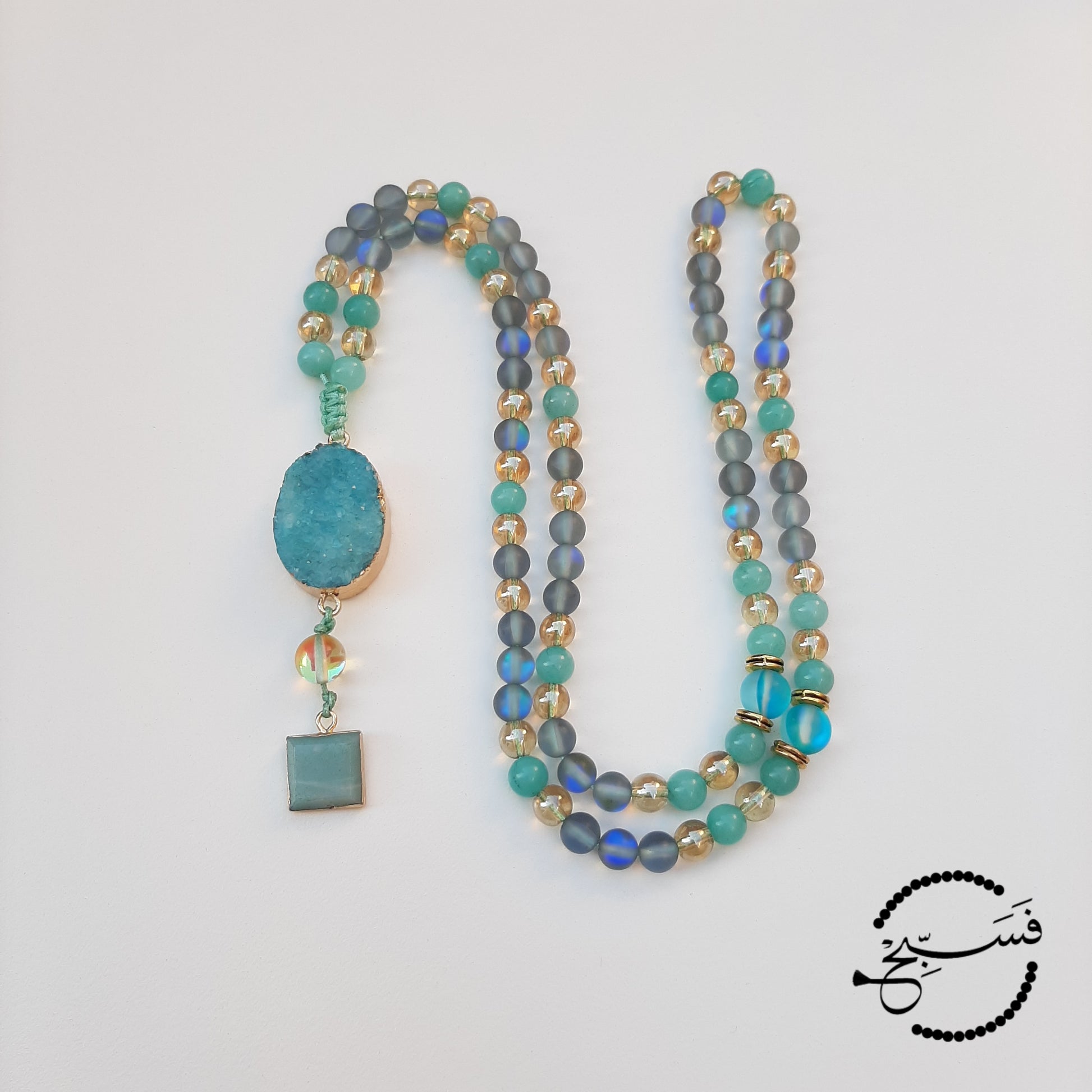 A different take on our best selling amazonite and moonstone combination. Natural amazonite beads, grey Austrian moonstone and gold beads make a stunning tasbih.  This version is finished with a druzy pendant and a mini amazonite pendant, for that little bit of extra luxury.  Packaged in a luxurious pouch and a gift box.  99 beads