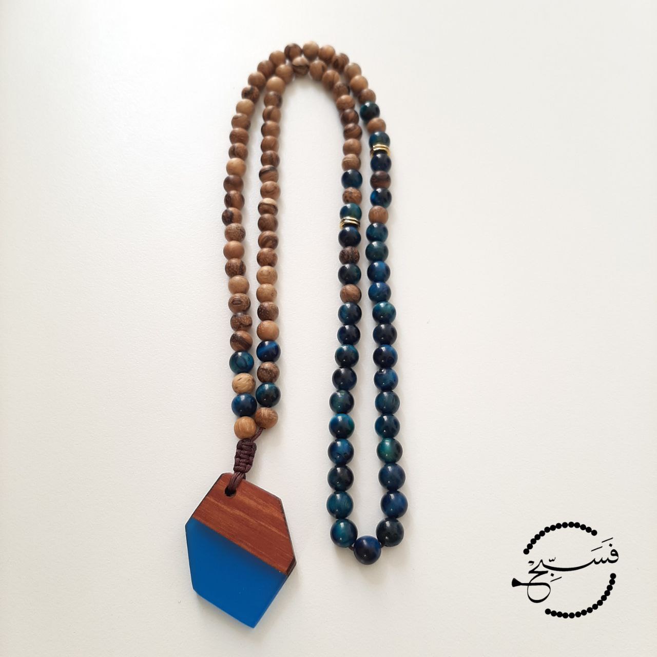 Gorgeous turquoise tiger eye beads with wood and a resin pendant.  Packaged in a luxurious pouch and a gift box.  99 beads