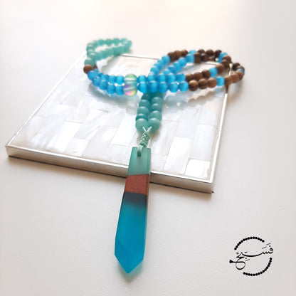Amazonite, cat eye and wood beads match this resin and wood pendant perfectly. These colours are gorgeous. Packaged in a luxurious pouch and a gift box.  99 beads