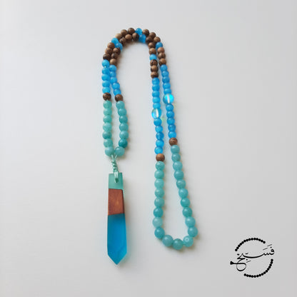 Amazonite, cat eye and wood beads match this resin and wood pendant perfectly. These colours are gorgeous. Packaged in a luxurious pouch and a gift box.  99 beads
