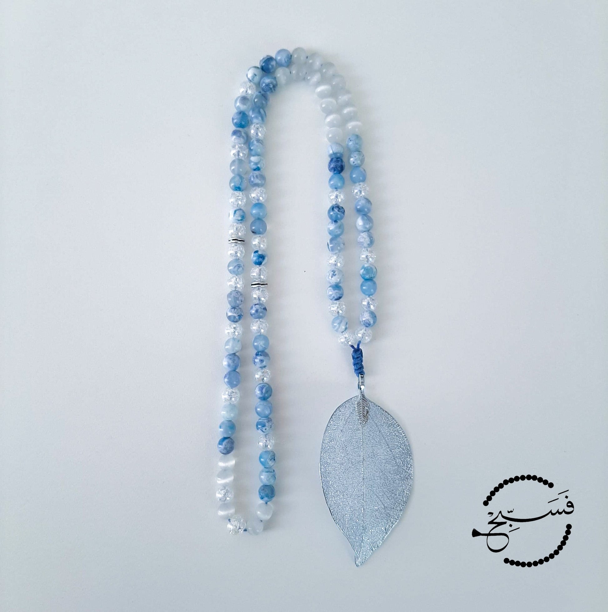 Blue fire agate beads tied together with a beautiful silvery-blue leaf.  Packaged in a luxurious pouch and a gift box.  99 beads