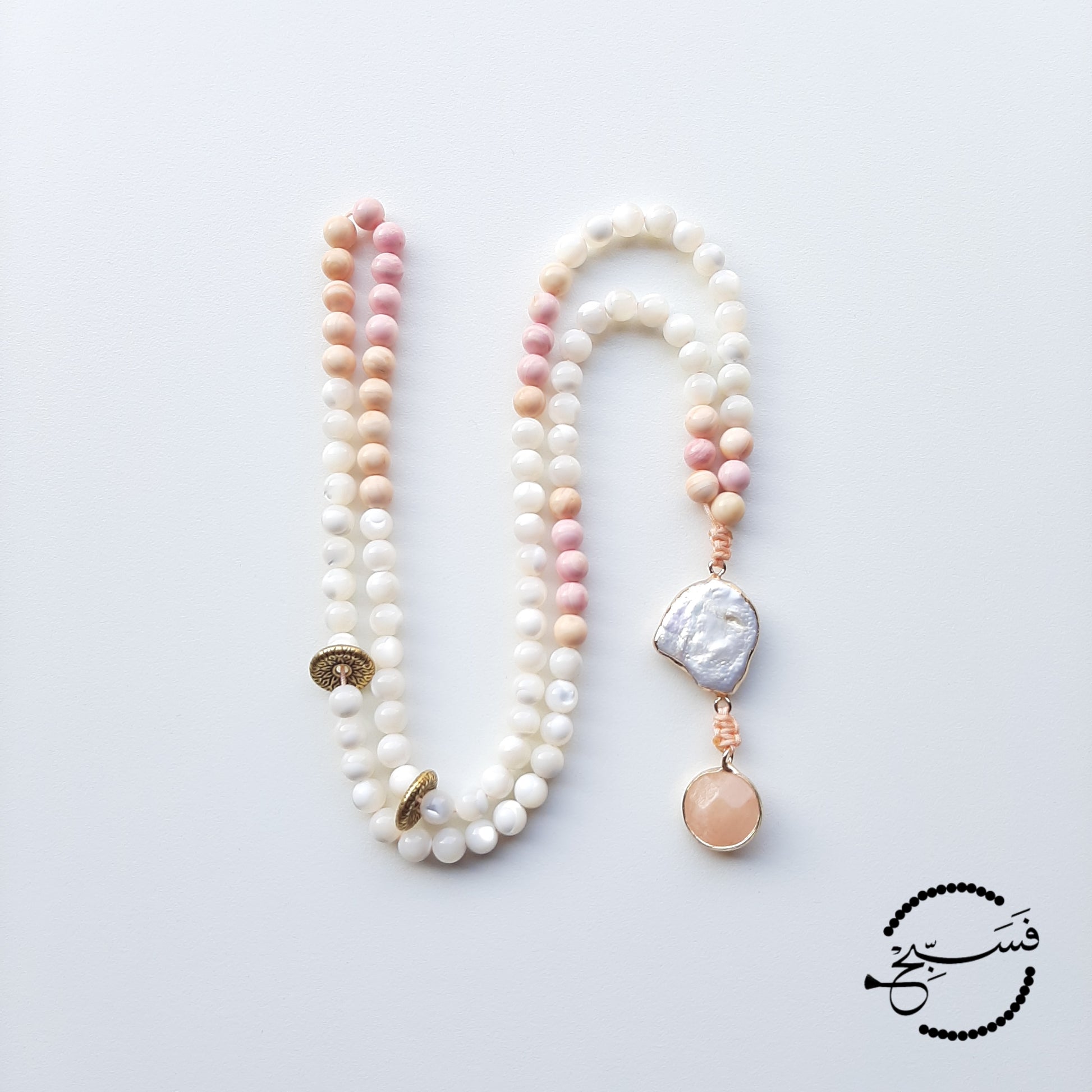 Natural trochus shell beads, pink and peach tridacna shell beads, a freshwater pearl pendant and a mini jasper pendant are used in this unique design.  Packaged in a luxurious pouch and a gift box.  99 beads