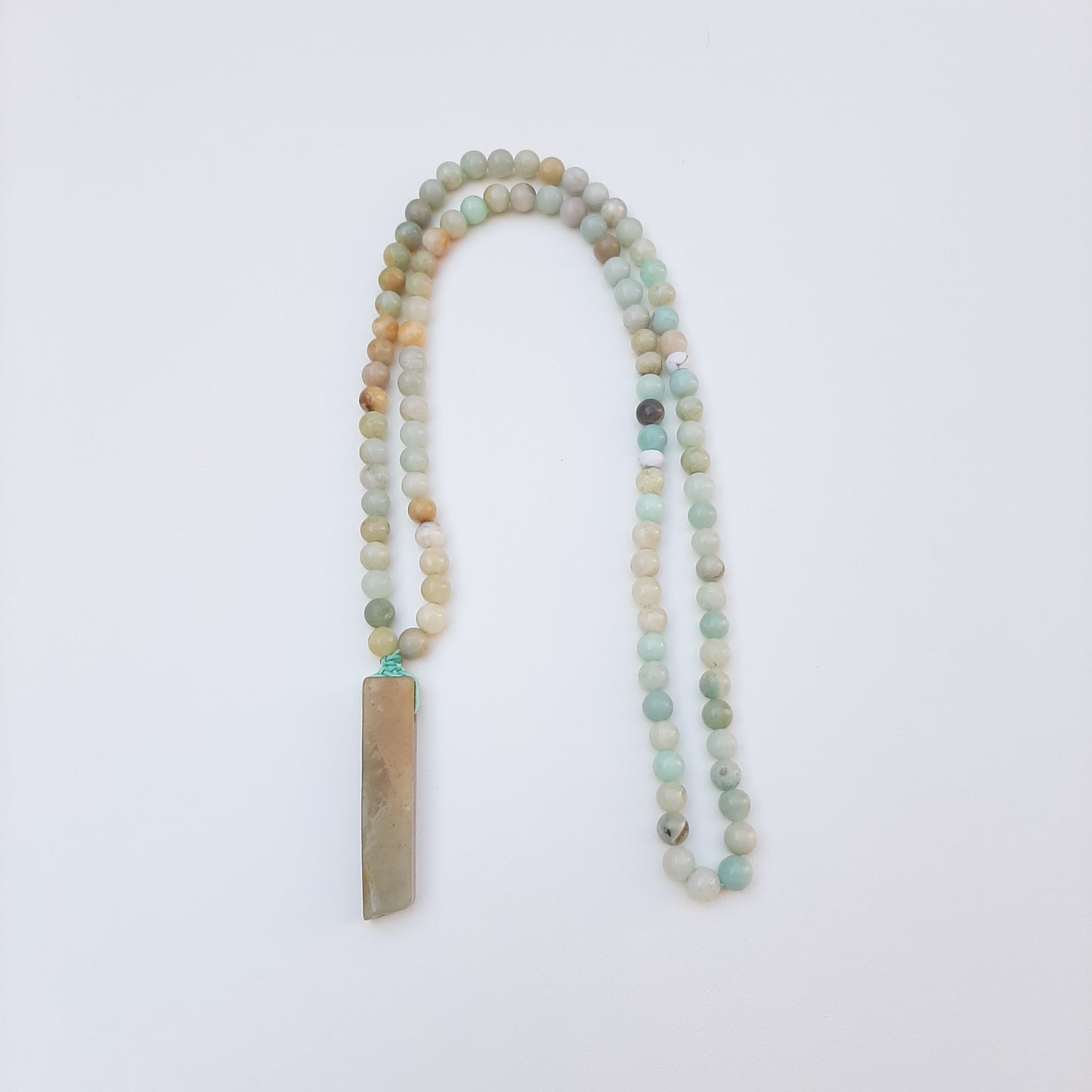 Mixed amazonite beads and stone.  Packaged in a luxurious pouch and a gift box.  99 beads