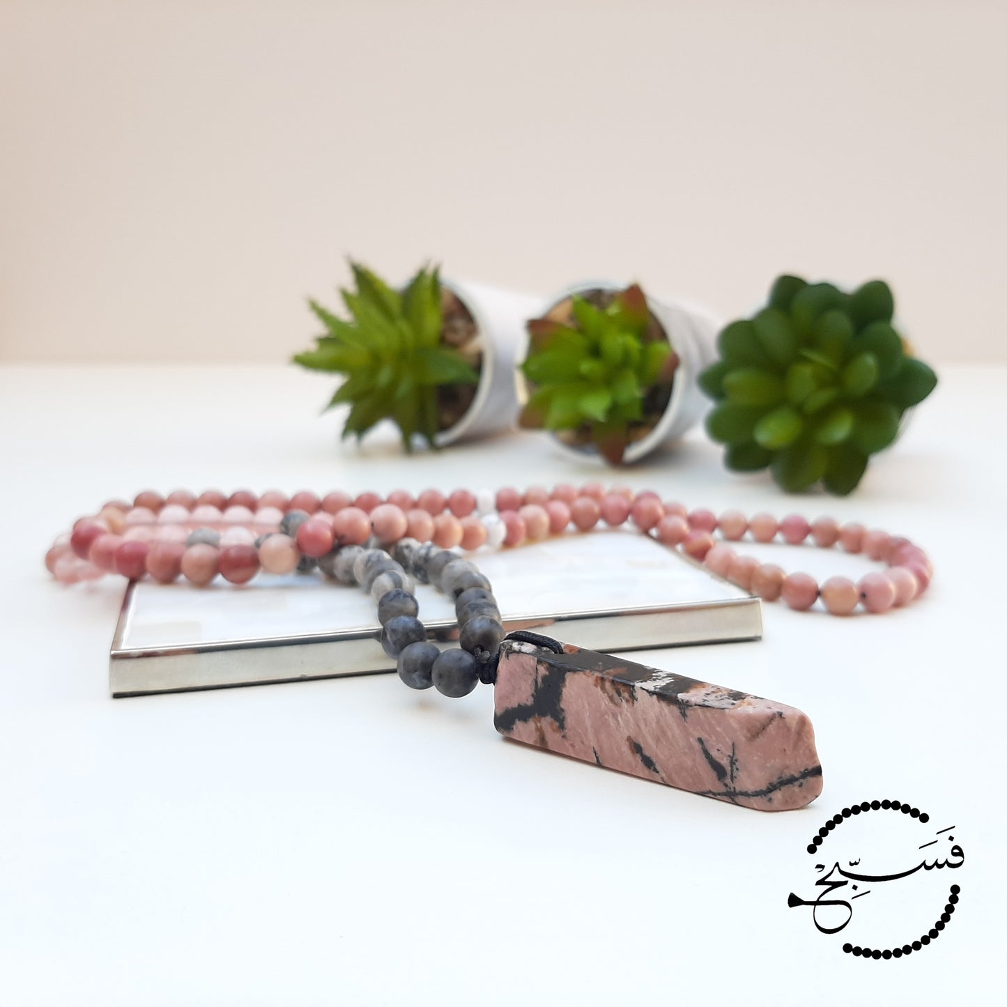 Rhodonite chip. The striking black marks have been reflected in the design of this piece, which features rhodonite, watermelon quartz and labradorite beads.  Packaged in a luxurious pouch and a gift box.  99 beads