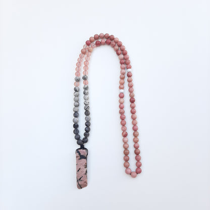 Rhodonite chip. The striking black marks have been reflected in the design of this piece, which features rhodonite, watermelon quartz and labradorite beads.  Packaged in a luxurious pouch and a gift box.  99 beads