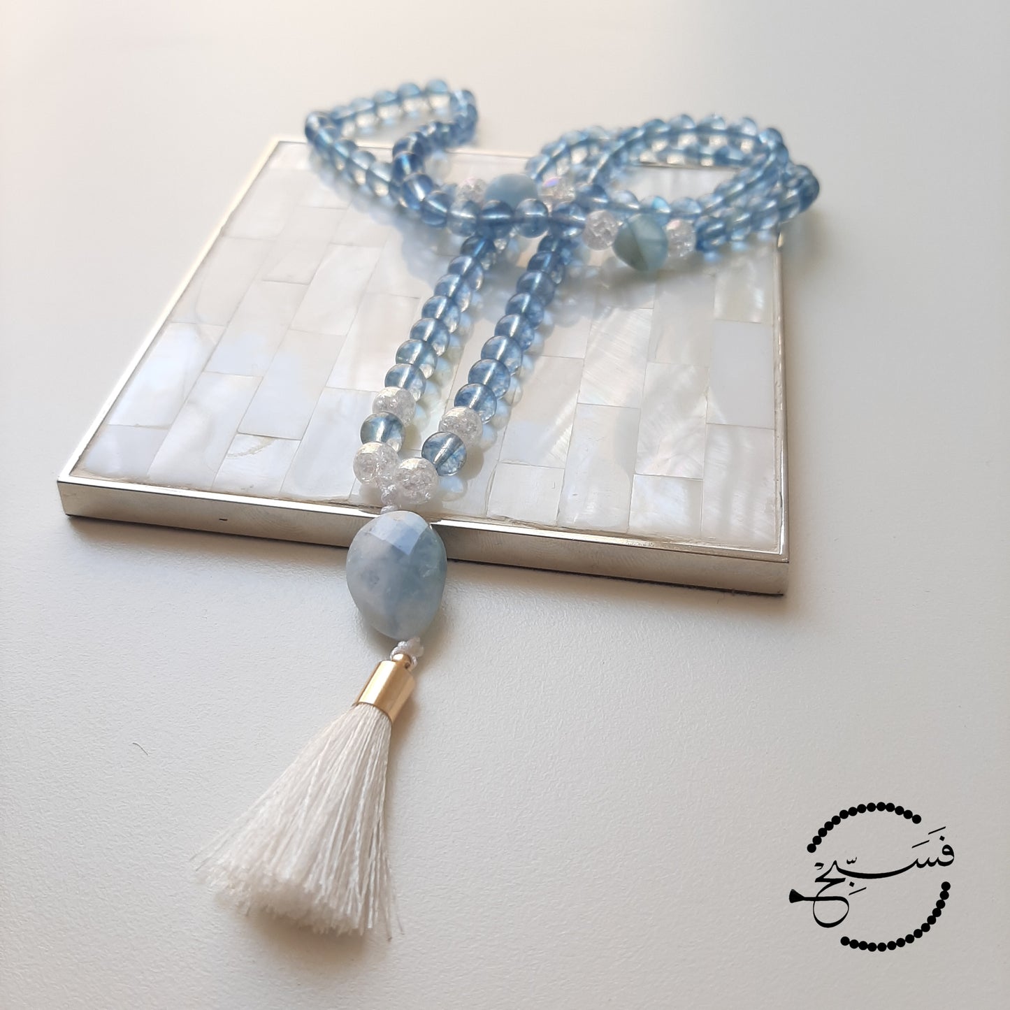 A gorgeous unisex design. The beads are blue topaz, with aquamarine spacers and pendant.  Packaged in a luxurious pouch and a gift box.  99 beads