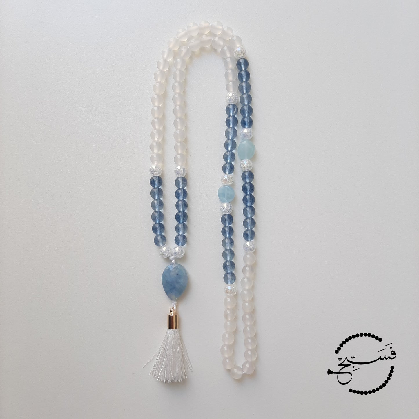 Aquamarine pendant and spacer beads, with white agate and blue topaz beads.  Packaged in a luxurious pouch and a gift box.  99 beads
