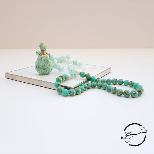 Amazonite perfume vial with amazonite and sea sediment beads. These little vials open up and come with a dropper so that you can add your favourite scent. Packaged in a luxurious pouch and a gift box.  99 beads