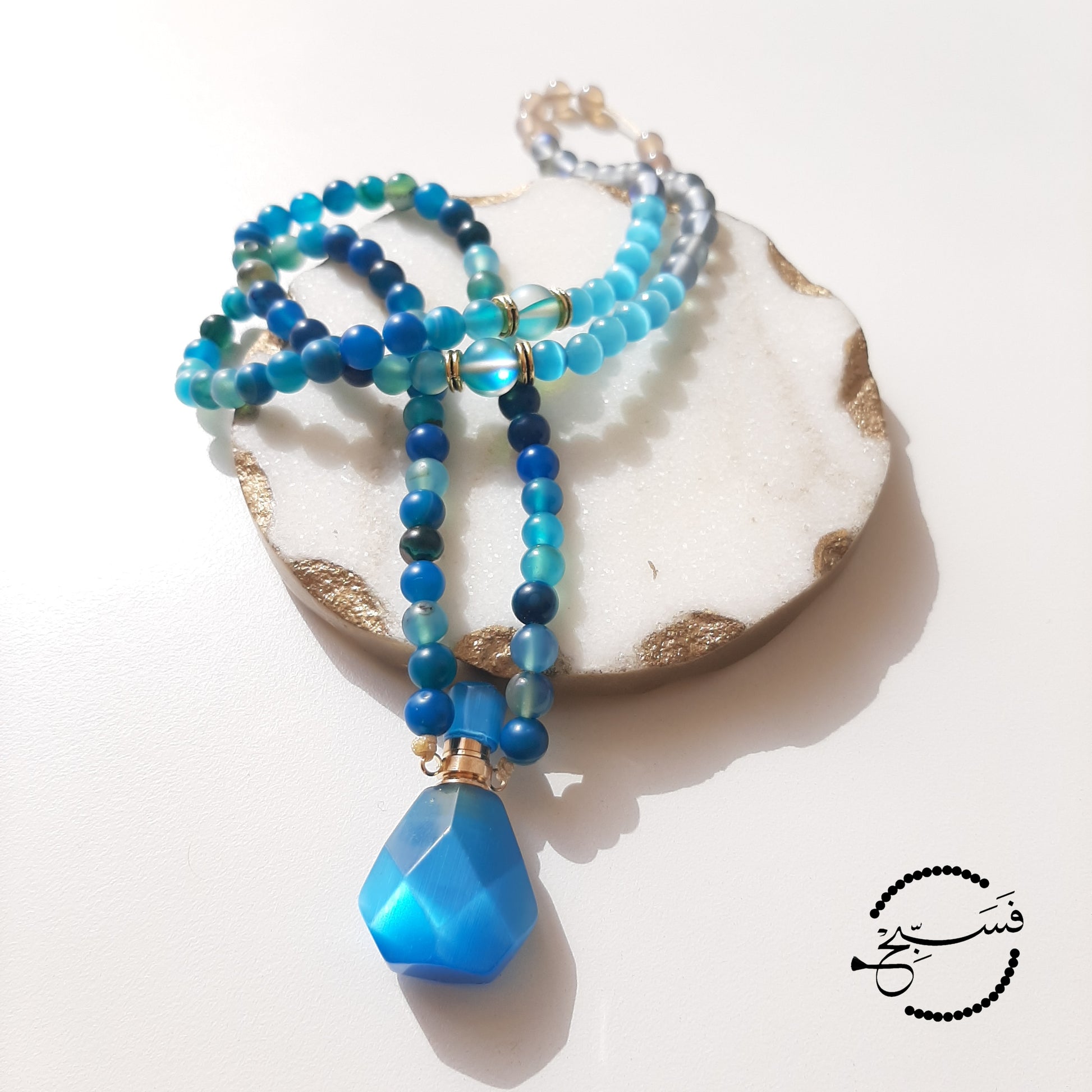 Blue agate perfume vial with a mixture of grey agate, Austrian moonstone, and cat-eye beads. These little vials open up and come with a dropper so that you can add your favourite scent.  Packaged in a luxurious pouch and a gift box.  99 beads