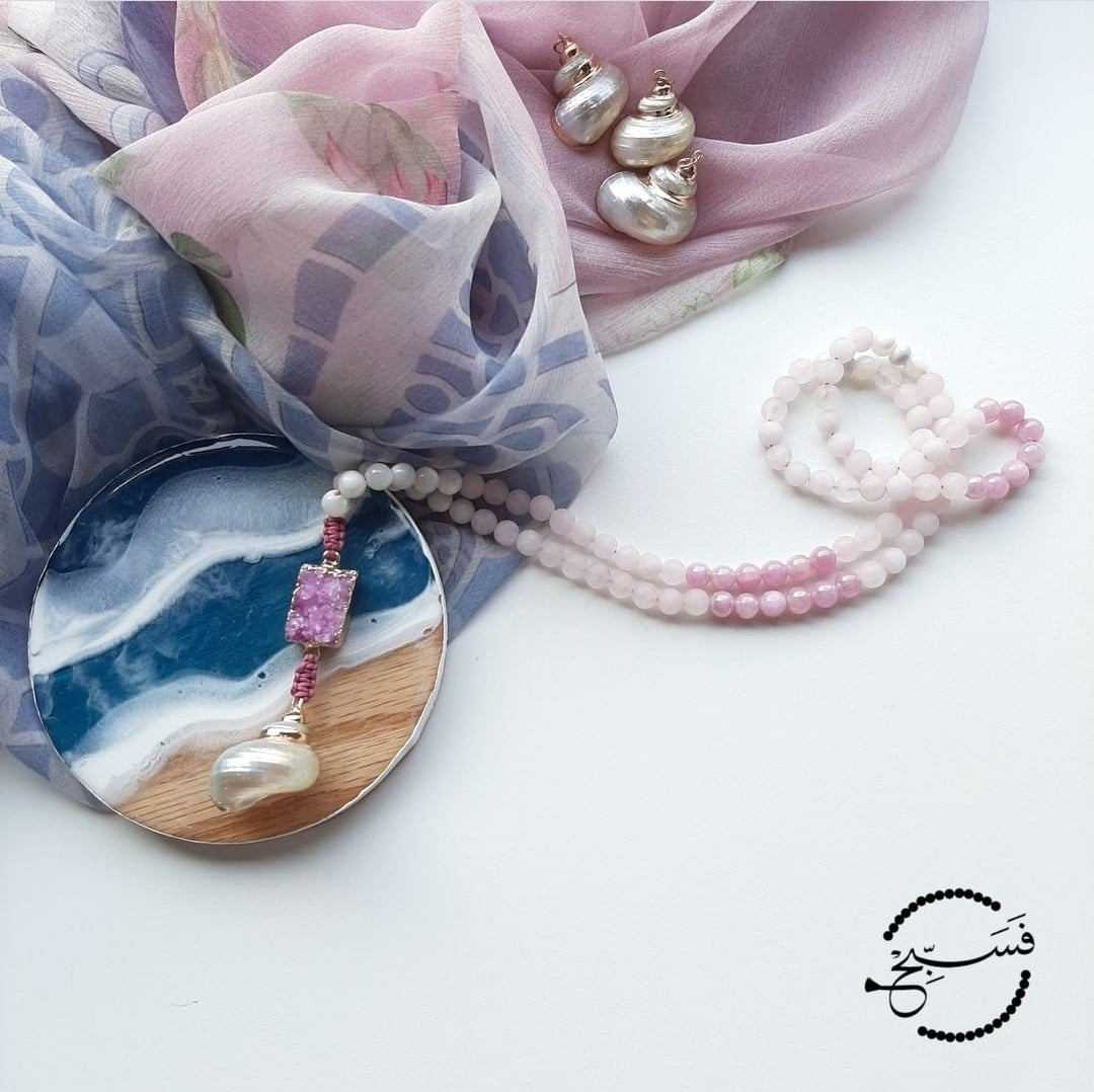 Shades of pink and lilac. White trochus shell, rose quartz, and lilac natural stone beads which have a beautiful shine due to their AB coating. Completed with a druzy pendant and a cute shell.  Packaged in a luxurious pouch and a gift box.  99 beads