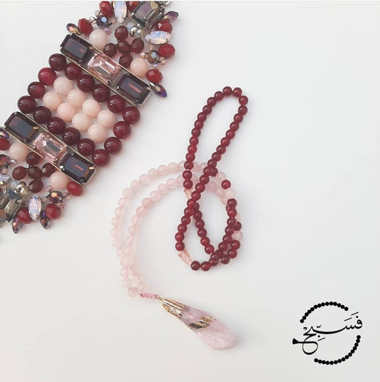 This feminine design incorporates rose quartz with deep red beads. Finished with a natural stone pendant.   Packaged in a luxurious pouch and a gift box.  99 beads