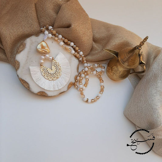 Natural trochus shell with matte white and gold beads. The pendant is freshwater pearl.  Packaged in a luxurious pouch and a gift box.  99 beads