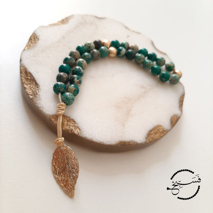 Green sea sediment beads, with a brass leaf.  Features an adjustable knot.  33 beads (6mm beads)
