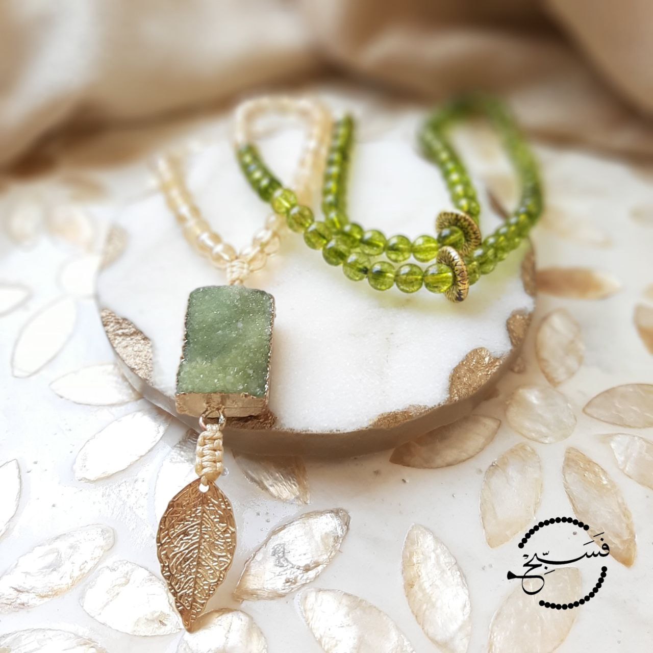 A green druzy pendant with gorgeous green peridot and smoky quartz beads.  Packaged in a luxurious pouch and a gift box.  99 beads