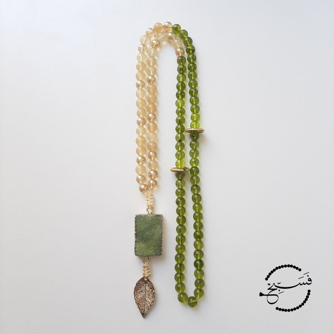 A green druzy pendant with gorgeous green peridot and smoky quartz beads.  Packaged in a luxurious pouch and a gift box.  99 beads