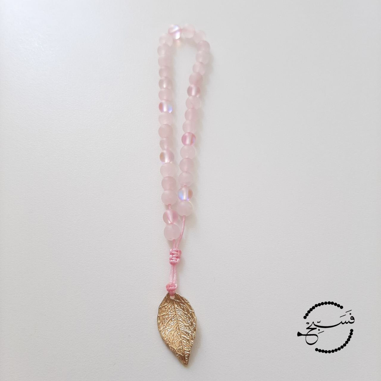 Rose quartz and moonstone beads, with a brass leaf.  Features an adjustable knot.  33 beads (6mm beads)