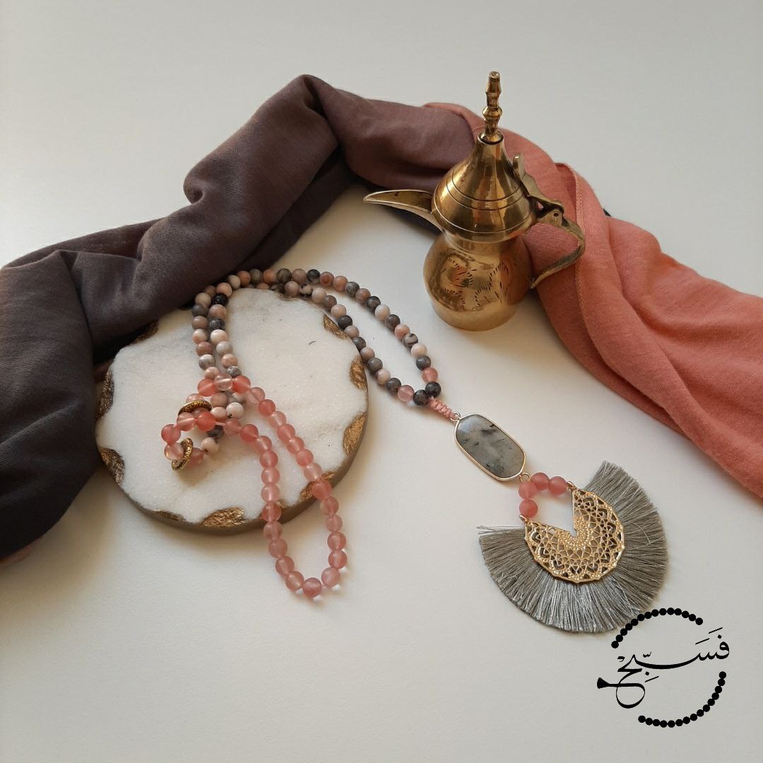 Pink zebra jasper and watermelon quartz beads, with a labradorite pendant grey fan tassel.  Packaged in a luxurious pouch and a gift box.  99 beads