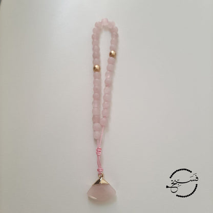 Rose quartz and matte gold beads, with a rose quartz pendant.  Features an adjustable knot.  33 beads (6mm beads)