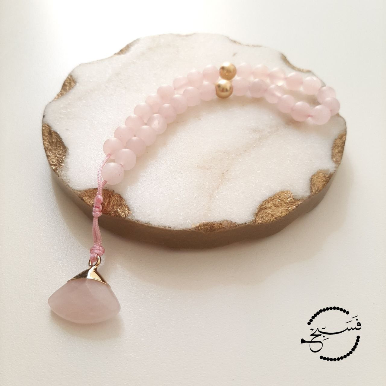 Rose quartz and matte gold beads, with a rose quartz pendant.  Features an adjustable knot.  33 beads (6mm beads)