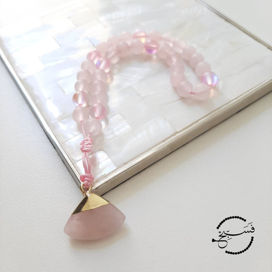 Rose quartz and moonstone beads, with a rose quartz pendant.  Features an adjustable knot.  33 beads (6mm beads)