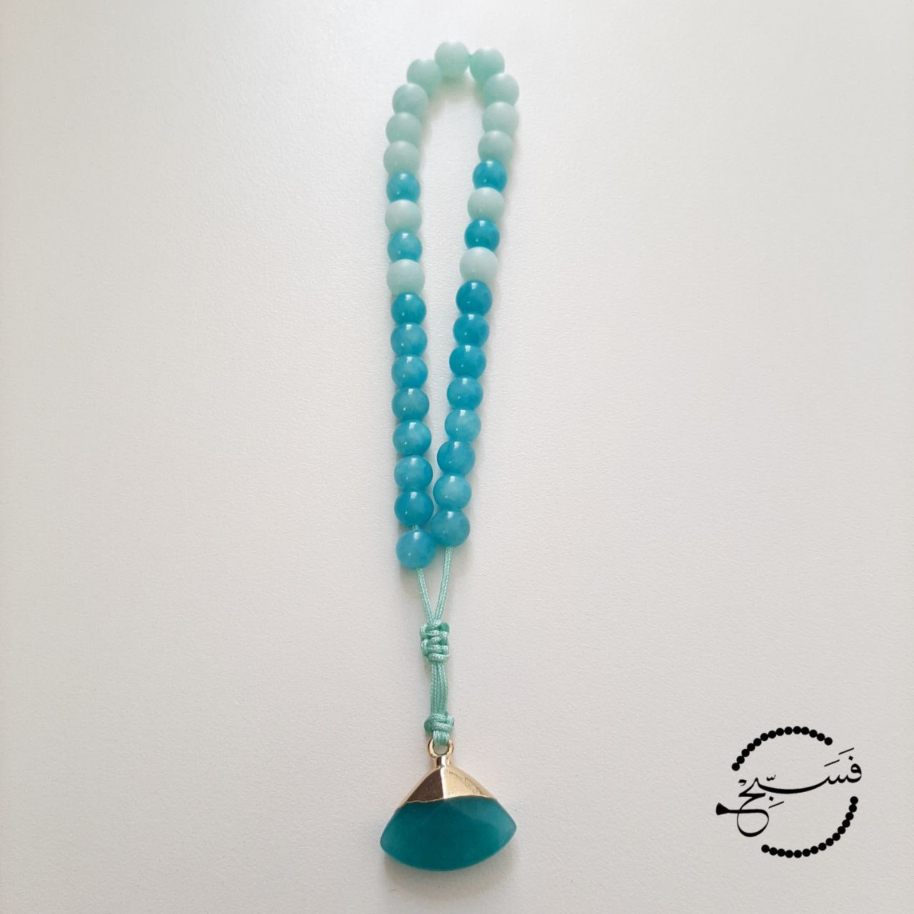 Amazonite beads with a fan-shaped pendant.  Features an adjustable knot.  33 beads (6mm beads)