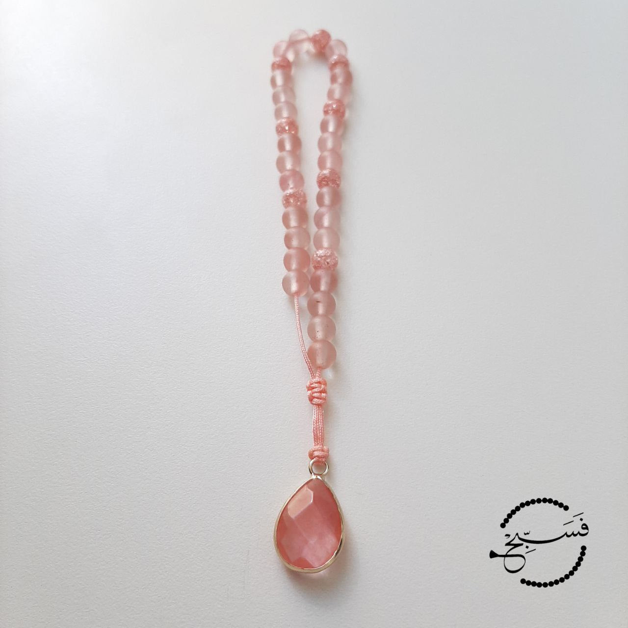 Watermelon quartz and crystal beads, with a watermelon quartz pendant.  Features an adjustable knot.  33 beads (6mm beads)