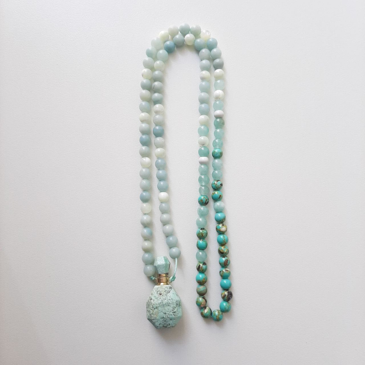 Amazonite perfume vial with amazonite and sea sediment beads. These little vials open up and come with a dropper so that you can add your favourite scent.  Packaged in a luxurious pouch and a gift box.  99 beads
