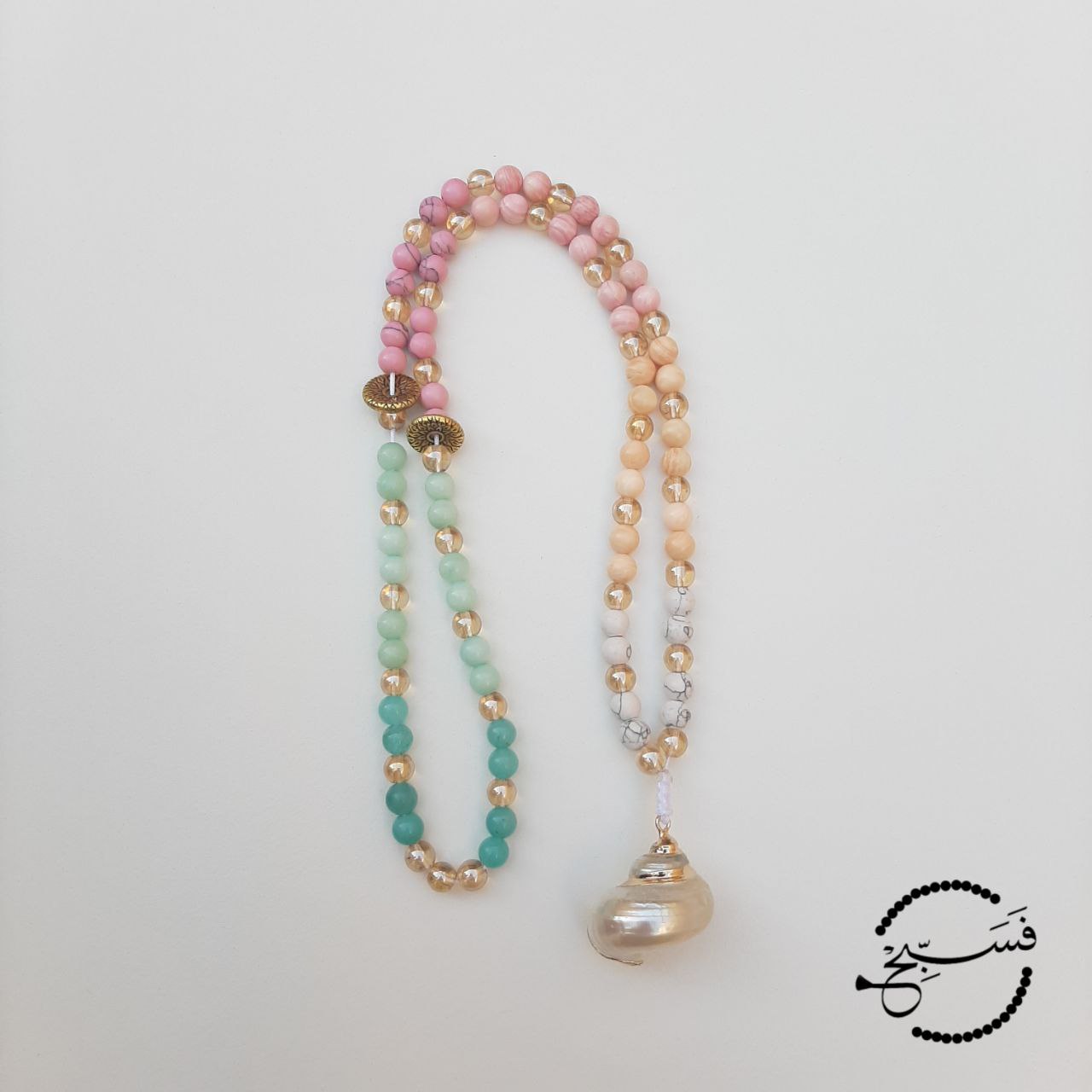 A mix of amazonite, howlite and tridacna shell beads, tied with a cute shell.  Packaged in a luxurious pouch and a gift box.  99 beads